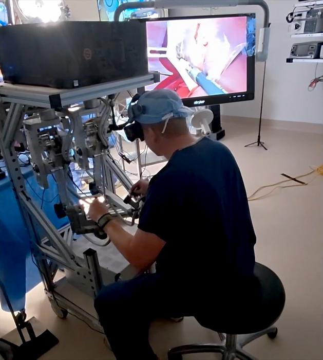 Surgie is not trusted to operate solo, even on a pig, so Dr. Ryan Broderick here teleoperated Surgie is not trusted to operate solo, even on a pig, so Dr. Ryan Broderick here teleoperated